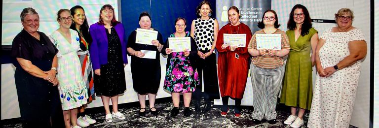 Kylie and other winners standing with their certificates